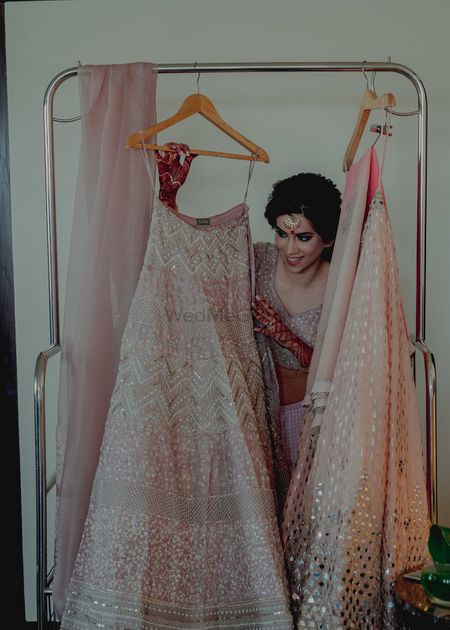 Photo of A bride posing with her pink pastel lehenga!