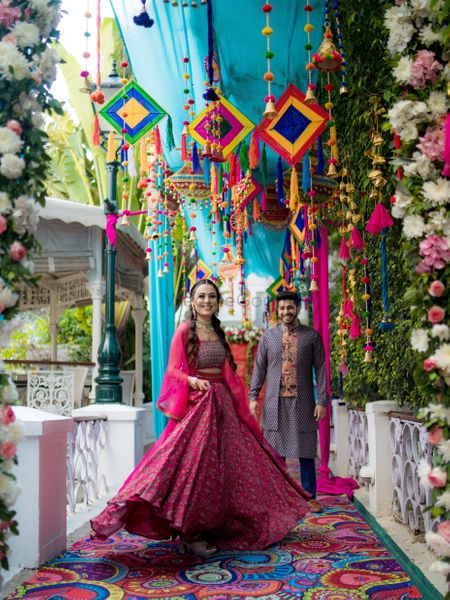 Bride in a bright pink lehenga for her mehendi
