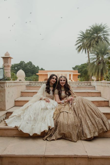 Bride with her sister on the wedding day with stunning lehengas