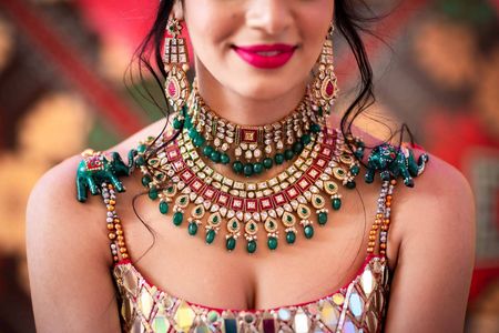 A shot of a bride wearing stunning layered jewellery.