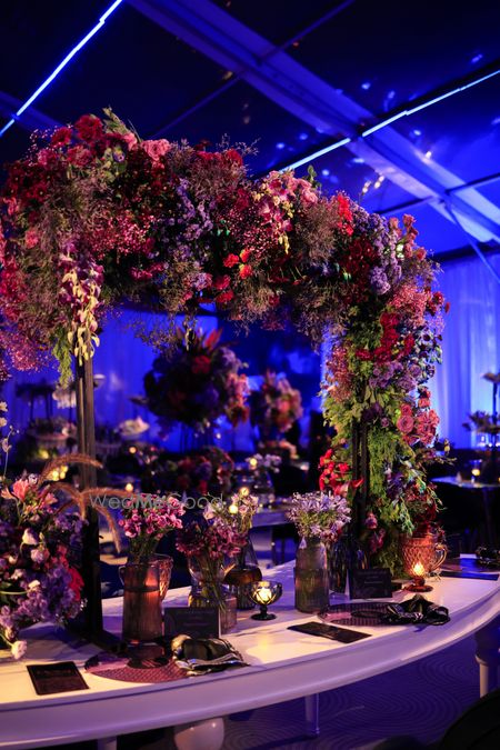 Photo of Unique table decor element with statement floral arrangement in mixed florals.