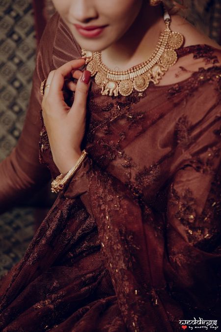 Photo of Lace saree for cocktail with gold necklace and jewellery