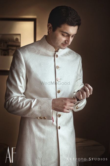 Photo of Off white sherwani with gold buttons