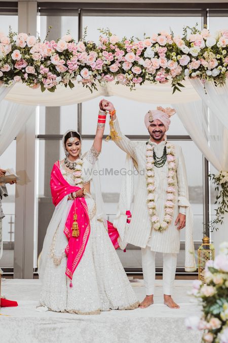 Photo of twinning bride and groom in white lehenga and sherwani
