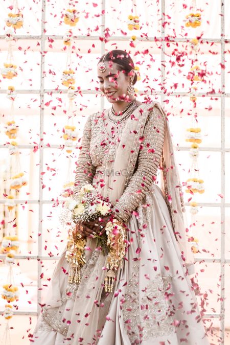 Photo of Pretty bridal portrait with petals thrown