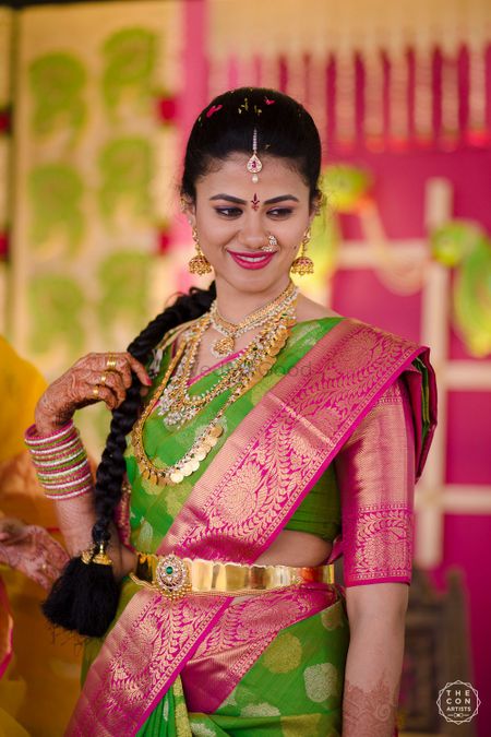 South Indian bridal look in pink and green saree 