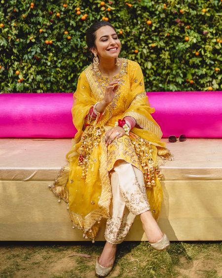 Photo of Bride in a yellow kurta for her mehendi