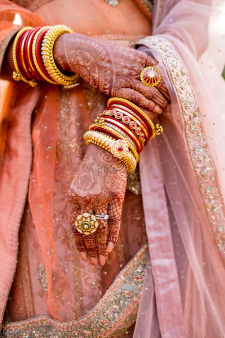 beautiful bridal hands with kadas and enamel ring