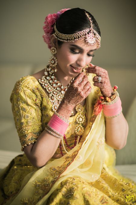 A bridal portrait captured as the bride shyly gets ready 