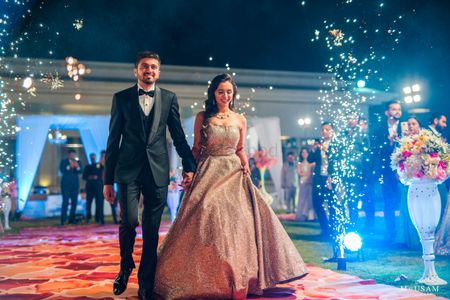 Photo of couple entry on reception with fireworks