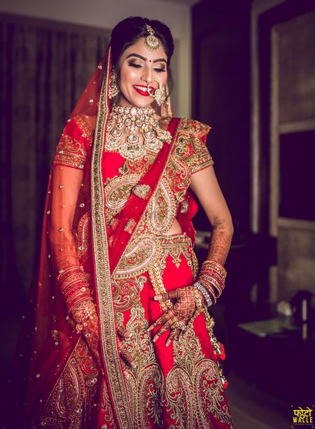 Photo of North indian bride in heavy lehenga and jewellery