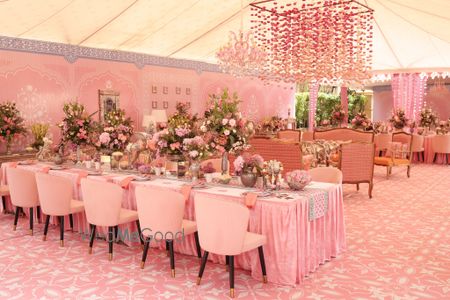 Stunning all-pink decor with floral centerpieces and hanging floral decor with pink chairs