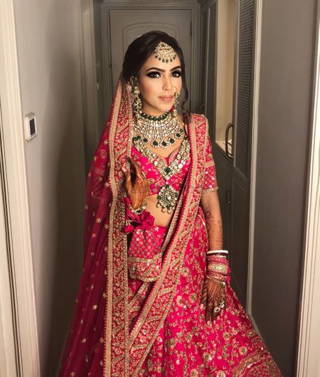Photo of Stunning bridal portrait of an indian bride wearing hot pink lehenga