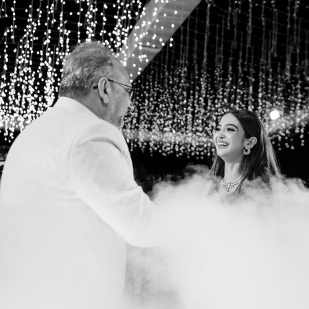 Photo of black and white portrait of bride with her father