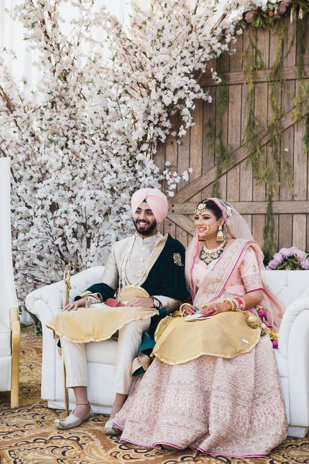 Photo of Coordinated sikh bride and groom in pink outfits