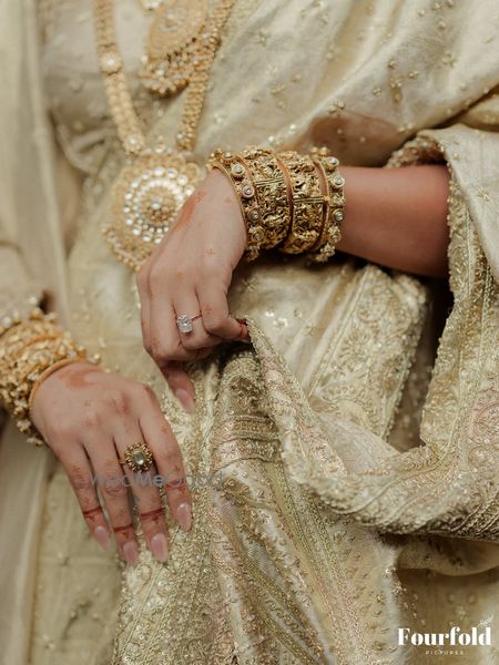 A gorgeous bangle and kada stack for the bride in pure gold and temple jewellery motifs