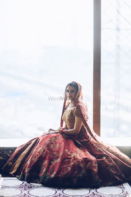 Bridal portrait with lehenga flared out by the window
