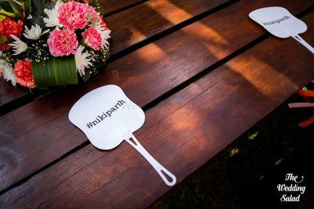 Fan for guests with wedding hashtag on it