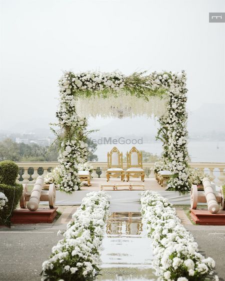 Gorgeous white and green mandap with a mirror aisle