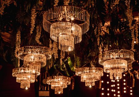 Photo of Beautiful chandelier décor for the bride and groom's cocktail/sangeet night.