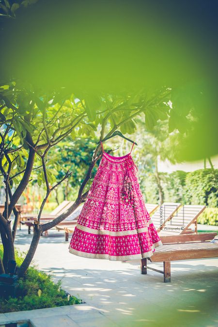 Photo of Bright pink and mint bridal lehenga on hanger