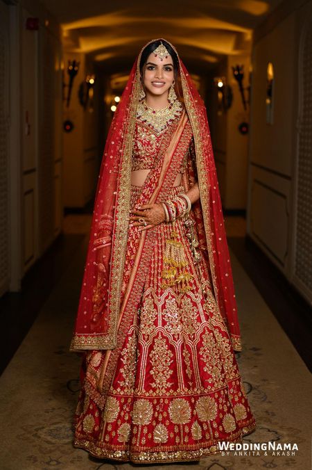 bride in traditional red and gold bridal lehenga with double dupatta
