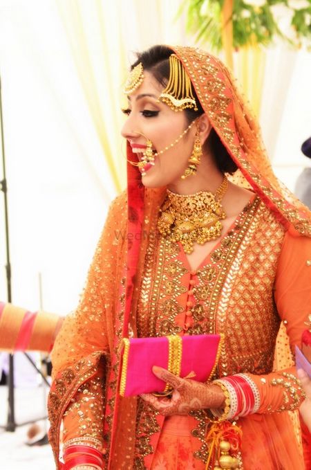 Photo of Candid Bride in Orange Anarkali by Sabyasachi