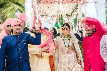 Bride entering with brothers carrying phoolon ka chadar
