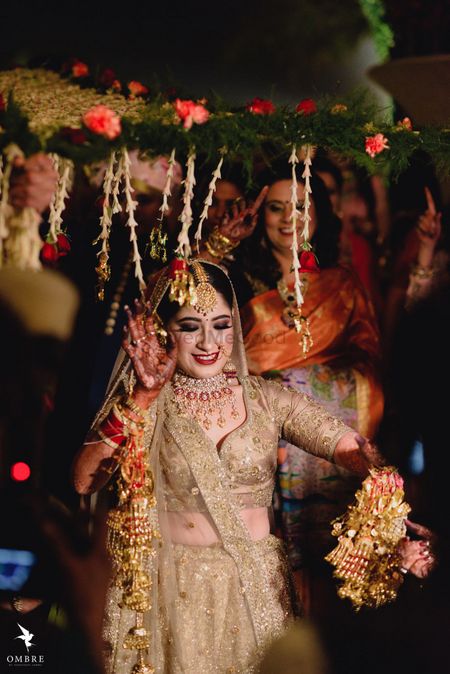 A bride in gold, dancing under the phoolon ki chadar
