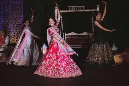 A bride dancing on stage with her bridesmaids 