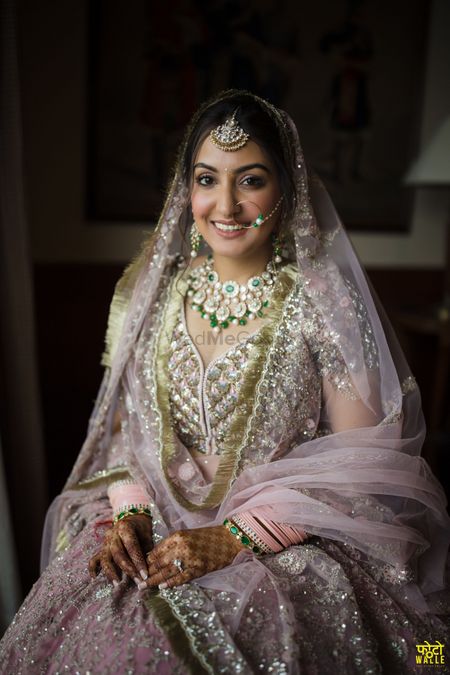 Gorgeous bridal portrait with the bride in a blush pink lehenga