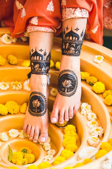 Feet Mehendi design with lotus motifs & tomb-like structures.