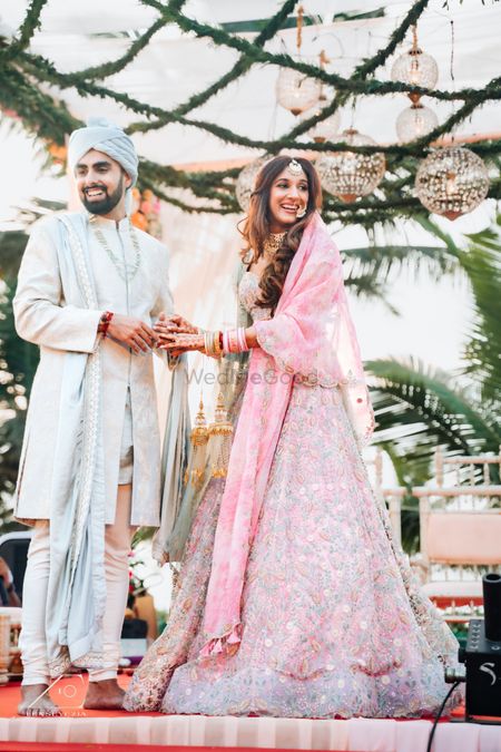 Bride and groom in pastel wedding outfits