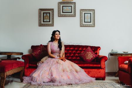 Bride in a dainty light pink lehenga for her engagement