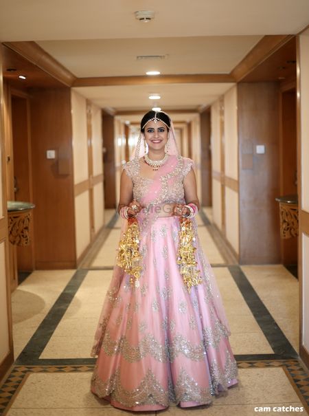 Light pink bridal lehenga with silver work and scalloped edge