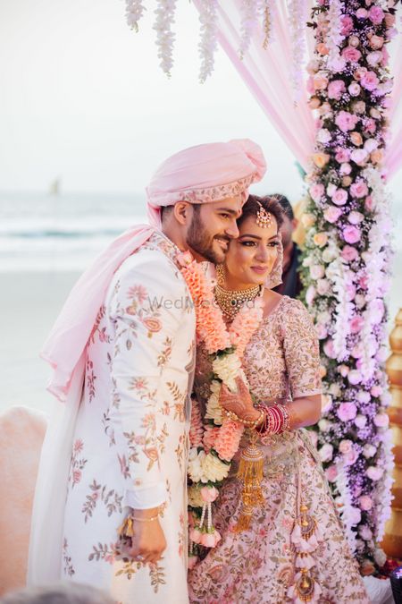 White and pink floral sherwani for groom 