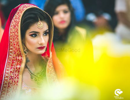 Photo of Gorgeous bridal portrait of a bride wearing red lehenga