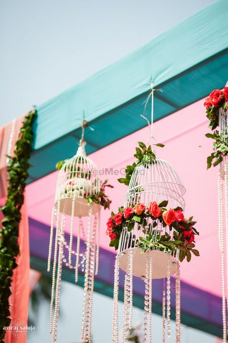 Hanging birdcages with crystals and flowers