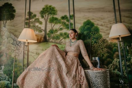 Peach bridal lehenga with stunning emerald and diamond jewellery 