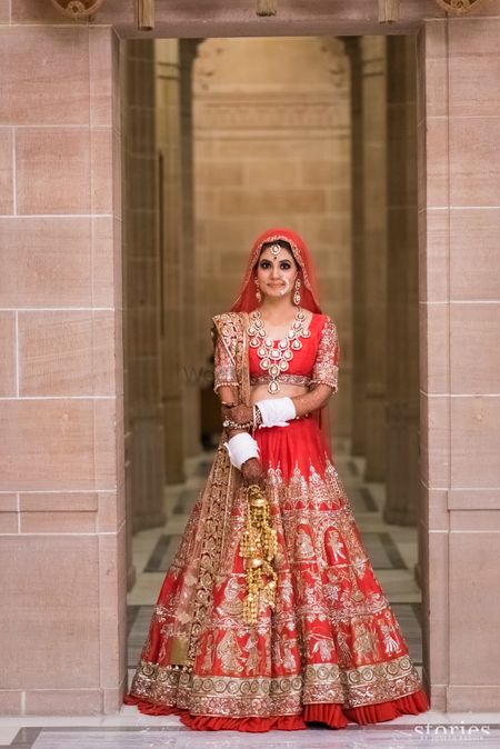 Photo of Red and gold bridal lehenga by manish malhotra