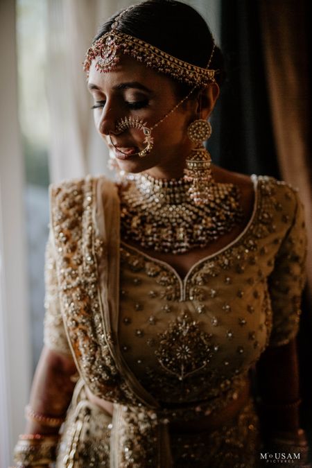 bridal close up shot with gold jewellery and lehenga