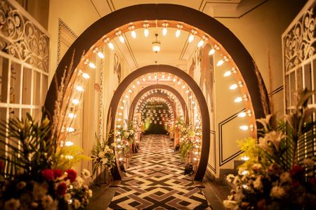 Glam entrance lined with lit tunnel for engagement ceremony