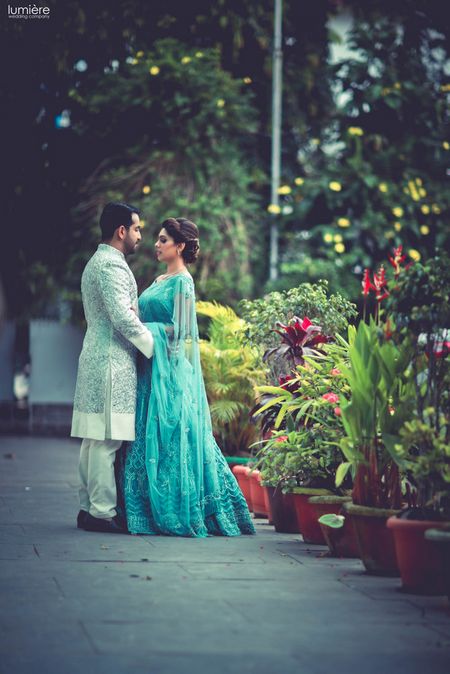 Outdoor couple shoot with bride in teal lehenga