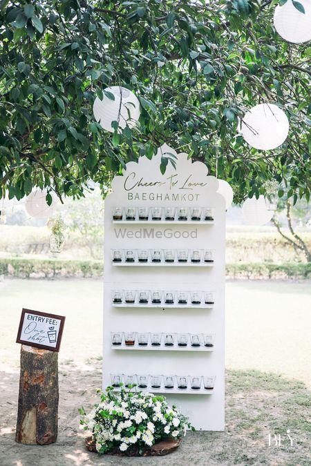 unique wedding station idea - shot wall seating chart