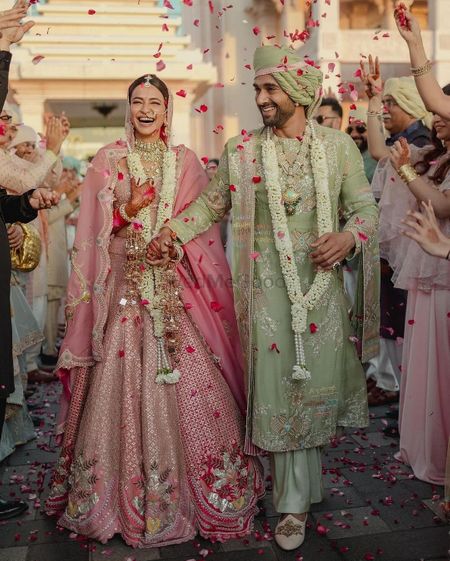 Stunning couple shot with the couple in Anamika khanna outfits in a pastel hue