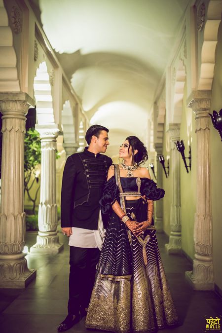 Photo of Black cocktail lehenga with ruffled off shoulder blouse