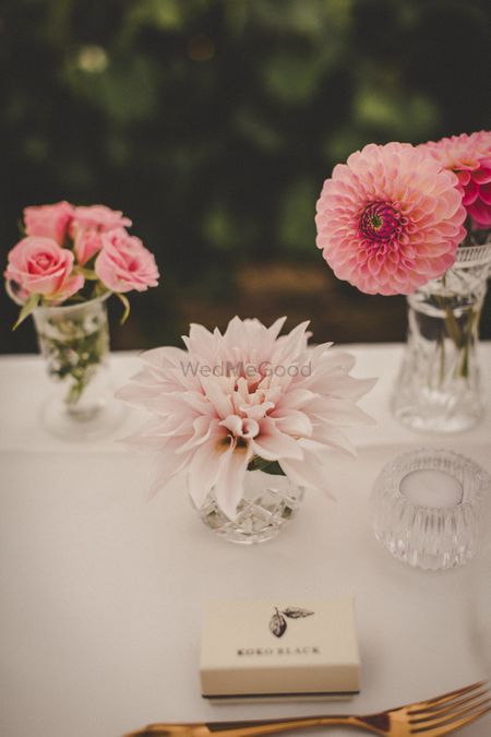 Photo of Table settings with crystal and pink at Indian wedding