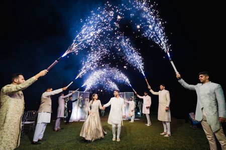 Photo of couple entry with guests holding sparklers