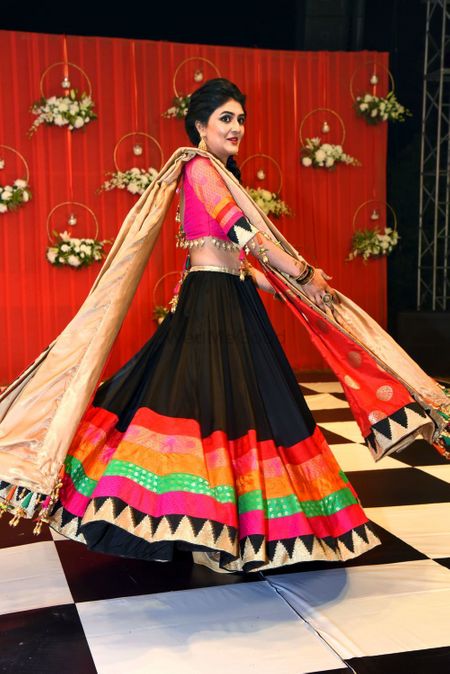 Bride twirling in quirky colourful lehenga