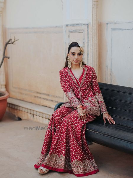 Photo of Heavy red sharara with gold and pearl jewellery for the mehendi look